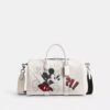 Geantă Disney X Coach Compass 35 cu Mickey Mouse