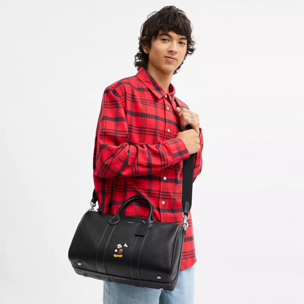 Geantă Disney X Coach Compass 35 cu Mickey Mouse