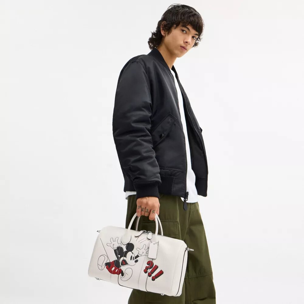 Geantă Disney X Coach Compass 35 cu Mickey Mouse