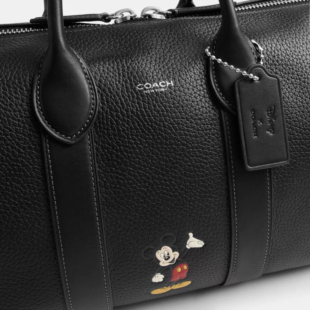 Geantă Disney X Coach Compass 35 cu Mickey Mouse