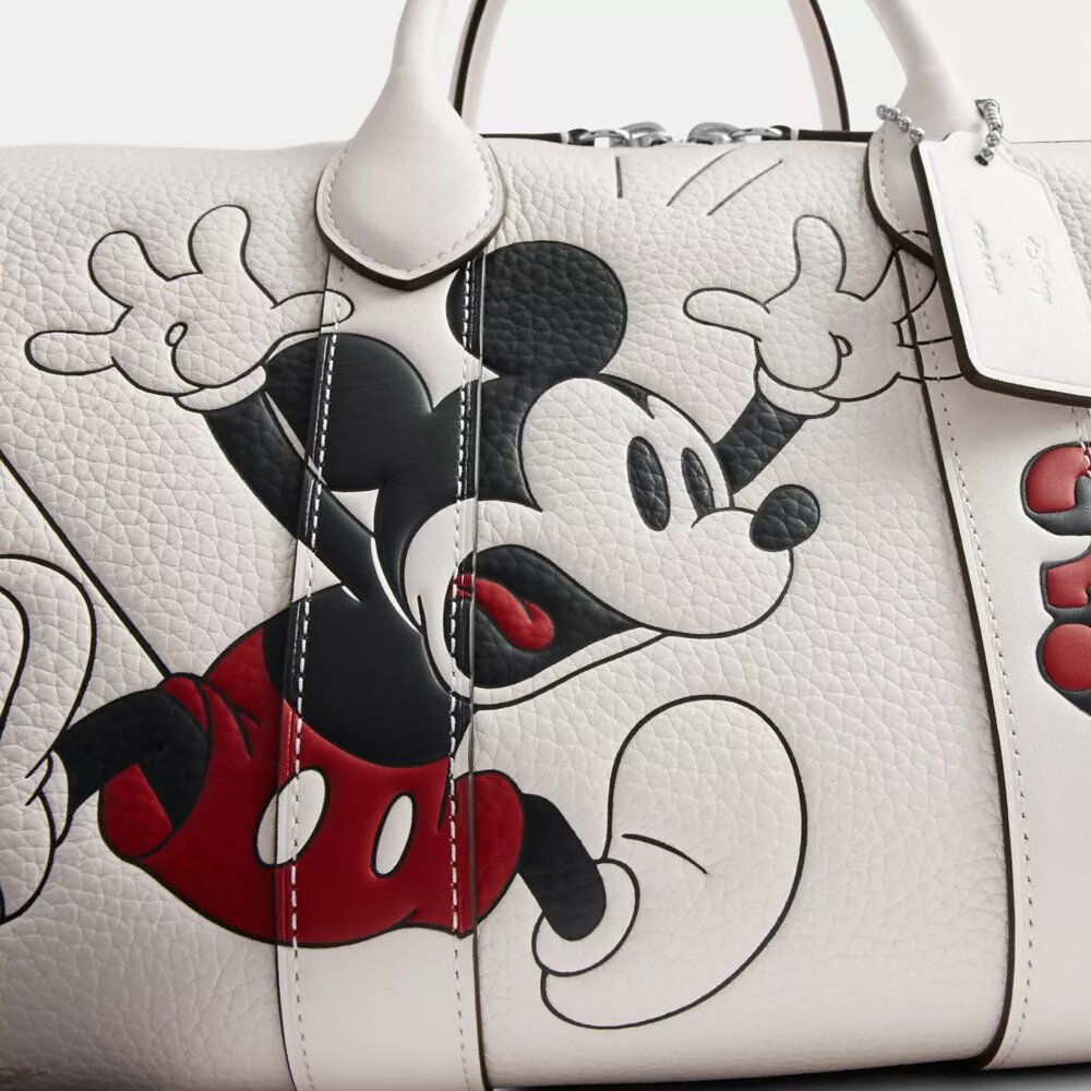 Geantă Disney X Coach Compass 35 cu Mickey Mouse